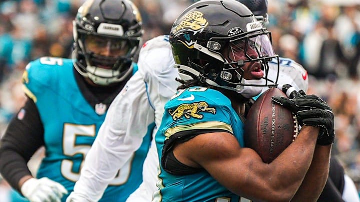 Jacksonville Jaguars running back Bhayshul Tuten (33) runs across the goal line to score a touchdown during the fourth quarter in an NFL football matchup at EverBank Stadium, Sunday, Jan. 4, 2026, in Jacksonville, Fla. The Jaguars defeated the Titans 41-7.