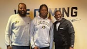 Four-star offensive tackle Carde Smith poses with Colorado head coach Deion Sanders during a September visit