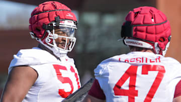 Arkansas Razorbacks offensive tackle Corey Robinson talking with fullback Maddox Lassiter during spring practice drills in Fayetteville, Ark.