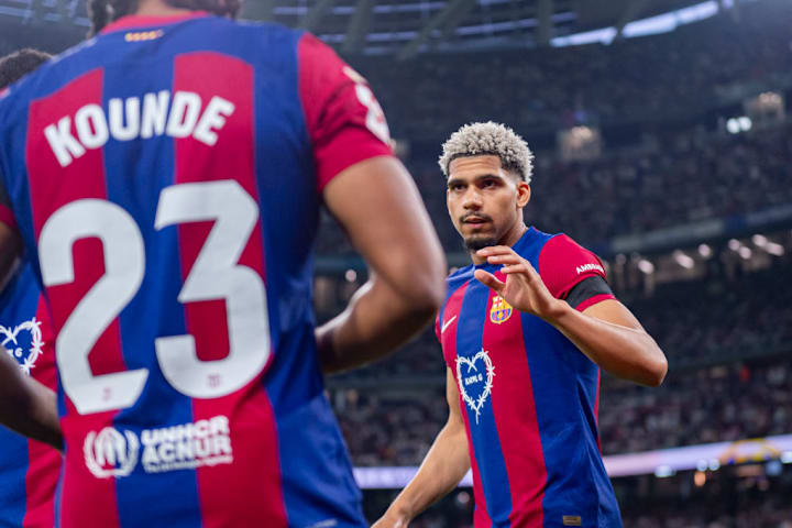 Ronald Araujo of FC Barcelona (R) seen cheering Jules Kounde...