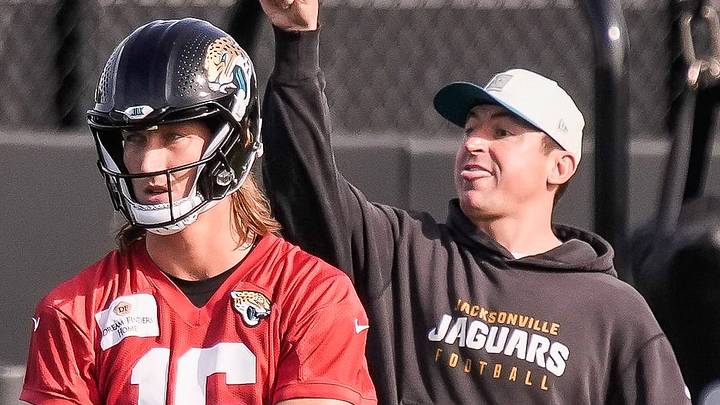 Jacksonville Jaguars Quarterback Trevor Lawrence (16) adjusts a sleeve on his trowing arm as Jacksonville Jaguars Offensive Coordinator Grant Udinski calls the next drill during the Jacksonville Jaguars seventh day of NFL Training Camp at the Miller Electric Center in Jacksonville, Fla., Thursday August 6, 2026. 