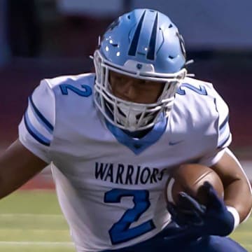 Central Valley running back Jance Henry (2) looks to make a move around Avonworth defensive back Billy Onyshko (13) during the Warriors Western Hills Conference matchup against Avonworth Friday night at Lenzner Field.