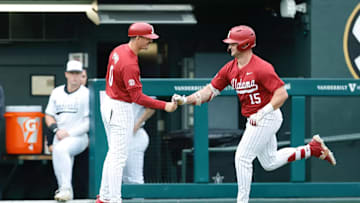 Alabama's Coleman Mizell (15) and assistant coach Anthony Papio (0).