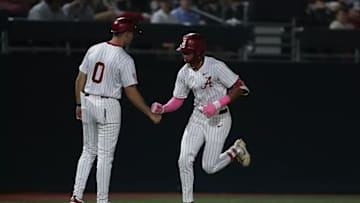 Alabama's Justin Lebron (1) and assistant coach Anthony Papio (0).