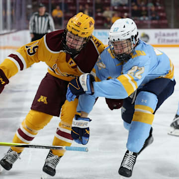 Gophers forward John Mittelstadt battling for the puck against Long Island.