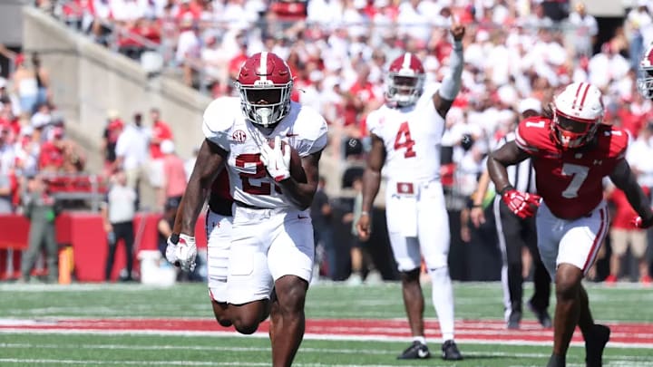 Alabama Running Back Jam Miller (26) runs the ball while Alabama Quarterback Jalen Milroe (4) celebrates against Wisconsin at Camp Randall Stadium in Madison, Wisconsin on Saturday, Sep 14, 2024.