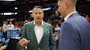 Alabama basketball coach Nate Oats talks to Robert Morris Head Coach Andrew Toole during pregame against Robert Morris during the first round of NCAA Men's Tournament at Rocket Arena in Cleveland, OH on Friday, Mar 21, 2025.