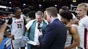 The Alabama Basketball Team huddles around Alabama basketball coach Nate Oats during an interview following the game against Saint Mary's at Rocket Arena in Cleveland, OH on Sunday, Mar 23, 2025.