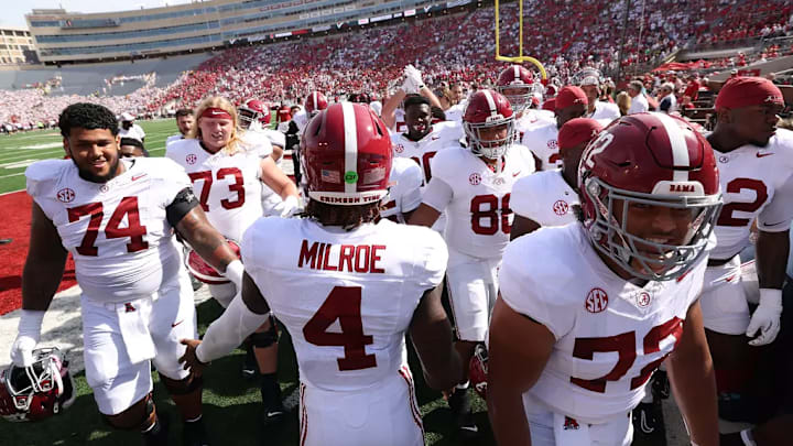 Alabama Quarterback Jalen Milroe (4) high fives The University of Alabama football team walk into the tunnel during pregame against Wisconsin at Camp Randall Stadium in Madison, Wisconsin on Saturday, Sep 14, 2024.