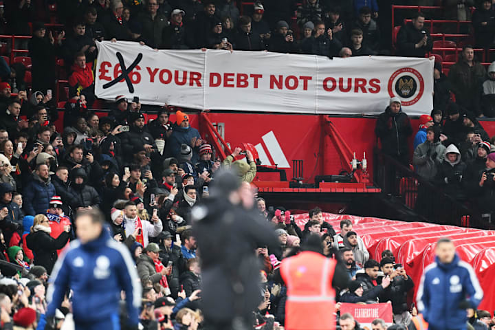 Man Utd's supporters unfurl a banner protesting raised ticket prices from the club's ownershi