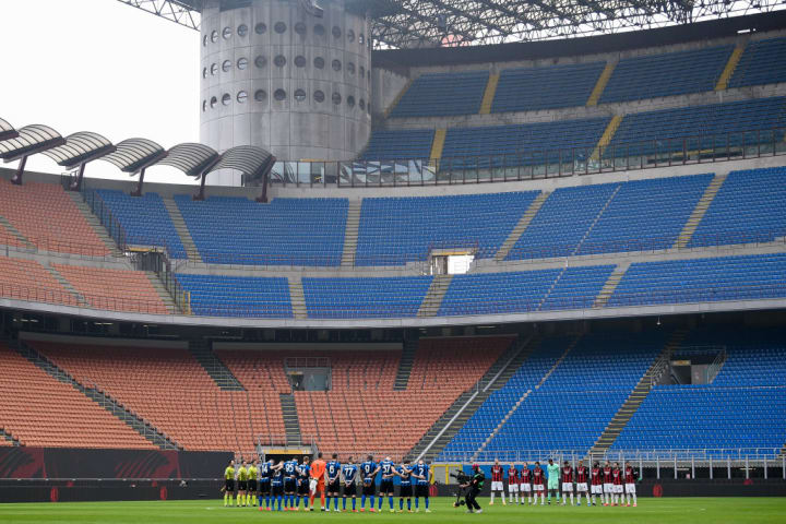 FC Internazionale and AC Milan players hold a minute of...