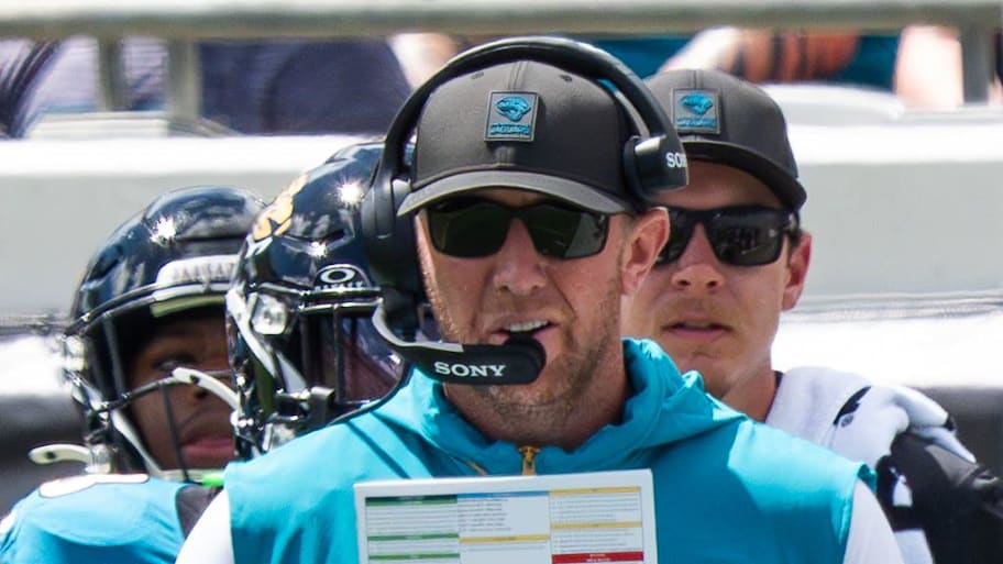 Liam Coen holding a play sheet.