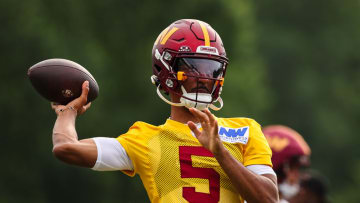 ASHBURN, VA - JULY 25: Jayden Daniels #5 of the Washington Commanders attempts a pass during training camp at OrthoVirginia Training Center at Commanders Park on July 25, 2024 in Ashburn, Virginia. 