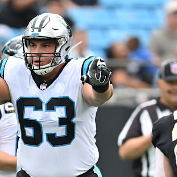 CHARLOTTE, NORTH CAROLINA - SEPTEMBER 25: Austin Corbett #63 of the Carolina Panthers looks over the New Orleans Saints defense during their game at Bank of America Stadium on September 25, 2022 in Charlotte, North Carolina.