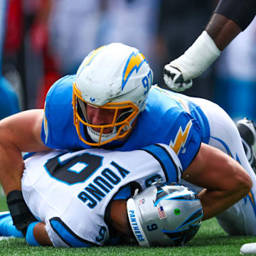 CHARLOTTE, NC - SEPTEMBER 15: Joey Bosa #97 of the Los Angeles Chargers sacks Bryce Young #9 of the Carolina Panthers during a football game at Bank of America Stadium on September 15, 2024 in Charlotte, North Carolina.