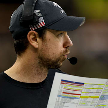 NEW ORLEANS, LOUISIANA - DECEMBER 1: Klint Kubiak, offensive coordinator for the New Orleans Saints, calls a play from the sideline during the second half of a game against the Los Angeles Rams at the Caesars Superdome on December 1, 2024 in New Orleans, Louisiana.