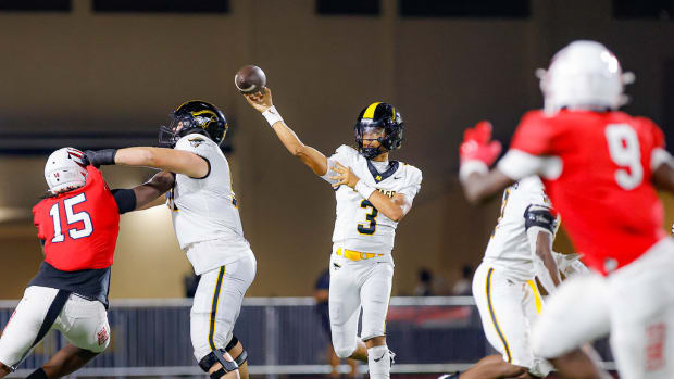 American Heritage quarterback Dia Bell throwing against Milton defense 