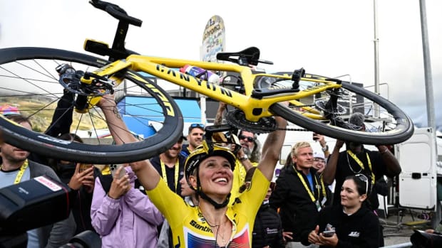 A champion bike racers holds her bike