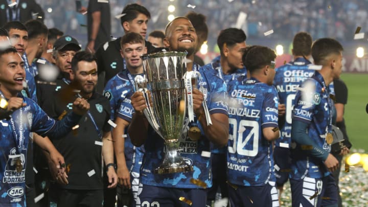 Salomon Rodon #23 of Pachuca lifts the trophy while...