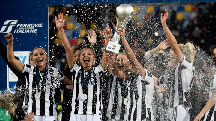 Arianna Caruso of Juventus FC raises the trophy while she...