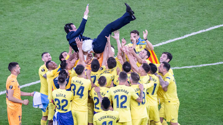 Players of Villarreal CF carry their coach Unai Emery during...