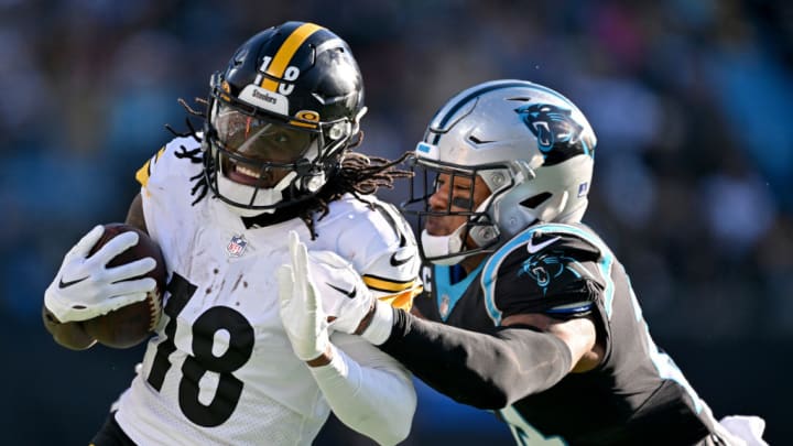 CHARLOTTE, NORTH CAROLINA - DECEMBER 18: Jeremy Chinn #21 of the Carolina Panthers tackles Diontae Johnson #18 of the Pittsburgh Steelers during the third quarter at Bank of America Stadium on December 18, 2022 in Charlotte, North Carolina.