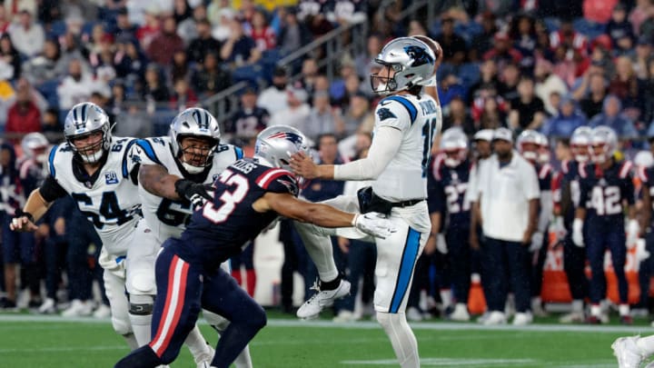 FOXBOROUGH, MA - AUGUST 08: Carolina Panthers quarterback Jack Plummer (16) throws pressured by New England Patriots linebacker Christian Elliss (53) during a preseason game between the New England Patriots and the Carolina Panthers on August 8, 2024, at Gillette Stadium in Foxborough, Massachusetts.