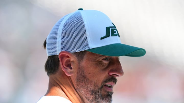 EAST RUTHERFORD, NEW JERSEY - AUGUST 10: Aaron Rodgers #8 of the New York Jets looks on against the Washington Commanders during the preseason game at MetLife Stadium on August 10, 2024 in East Rutherford, New Jersey. The Jets defeated the Commanders 20-17.