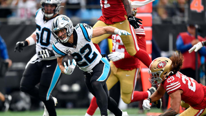 CHARLOTTE, NORTH CAROLINA - OCTOBER 09: Christian McCaffrey #22 of the Carolina Panthers fights off defenders of the San Francisco 49ers during the second half of the game at Bank of America Stadium on October 09, 2022 in Charlotte, North Carolina. 