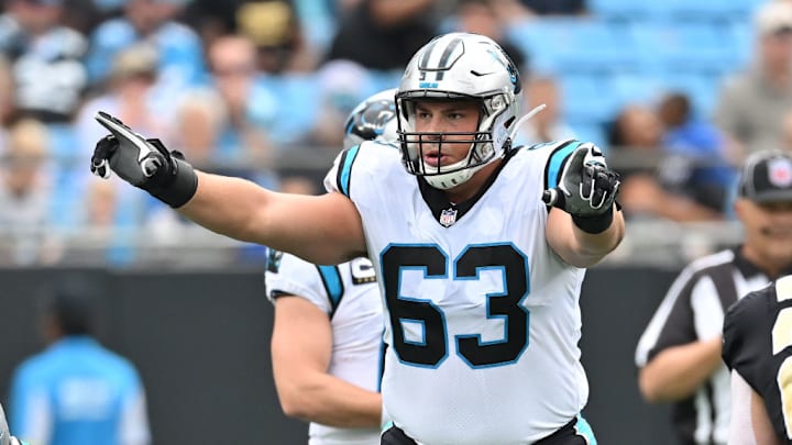 CHARLOTTE, NORTH CAROLINA - SEPTEMBER 25: Austin Corbett #63 of the Carolina Panthers looks over the New Orleans Saints defense during their game at Bank of America Stadium on September 25, 2022 in Charlotte, North Carolina.