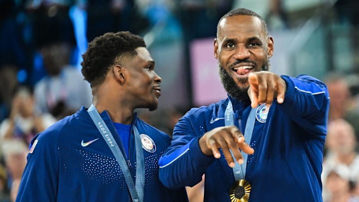 Gold medallists USA's #05 Anthony Edwards (L) and USA's #06 LeBron James pose on the podium after the men's Gold Medal basketball match between France and USA during the Paris 2024 Olympic Games at the Bercy Arena in Paris on August 10, 2024. (Photo by Damien MEYER / AFP)