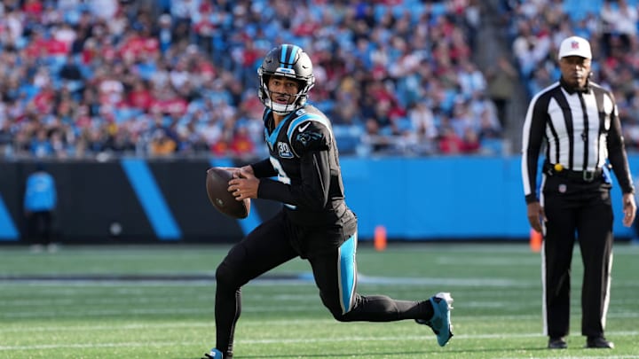 CHARLOTTE, NORTH CAROLINA - NOVEMBER 24: Quarterback Bryce Young #9 of the Carolina Panthers rolls out of the pocket during the third quarter against the Kansas City Chiefs at Bank of America Stadium on November 24, 2024 in Charlotte, North Carolina.