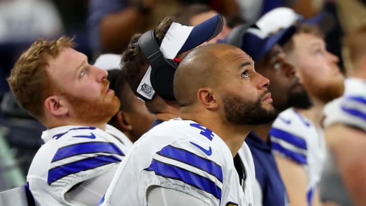 ARLINGTON, TEXAS - JANUARY 14: Dak Prescott #4 of the Dallas Cowboys looks on from the bench during the NFC Wild Card Playoff game against the Green Bay Packers at AT&T Stadium on January 14, 2024 in Arlington, Texas.