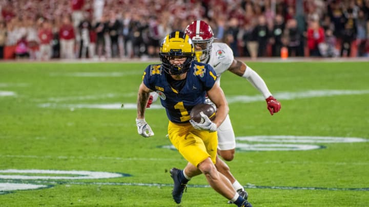 PASADENA, CALIFORNIA - JANUARY 01: Roman Wilson #1 of the Michigan runs with the ball for yardage away from Malachi Moore #13 of the Alabama Crimson Tide during the second half of the CFP Semifinal Rose Bowl Game at Rose Bowl Stadium on January 01, 2024 in Pasadena, California. The Michigan Wolverines won the game 27-20 in overtime.