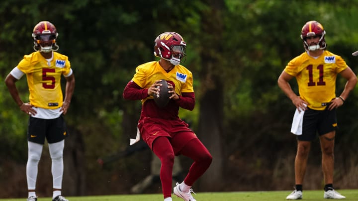 ASHBURN, VA - JULY 25: Jayden Daniels #5, Marcus Mariota #0, and Sam Hartman #11 of the Washington Commanders participate in a drill during training camp at OrthoVirginia Training Center at Commanders Park on July 25, 2024 in Ashburn, Virginia. 