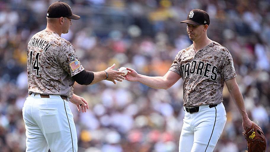 Padres manager Craig Stammen (left) takes the ball from starting pitcher Walker Buehler