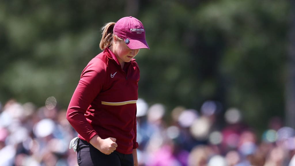 Golfer Lottie Woad pumps her fist after a made putt at the Augusta National Women's Amateur.