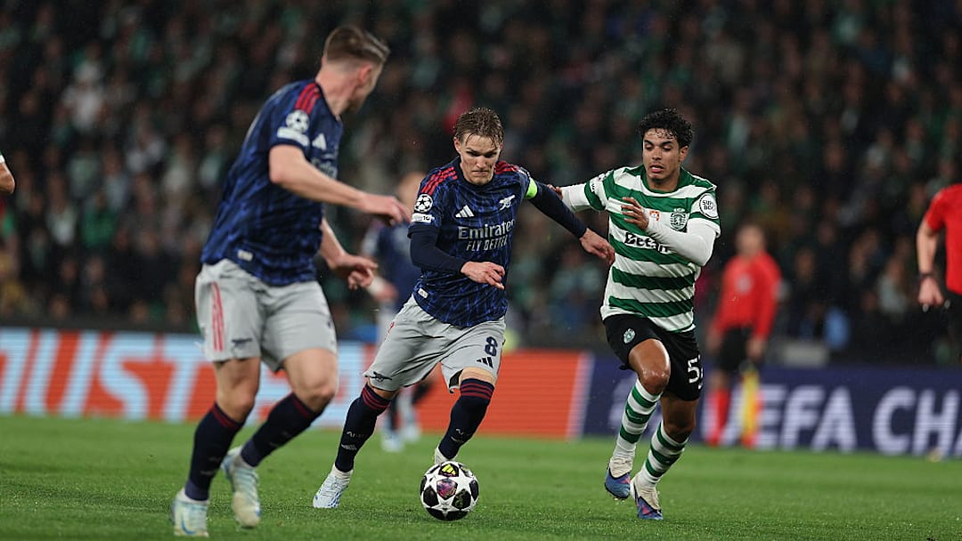 Arsenal escaped Lisbon with a last-gasp victory.