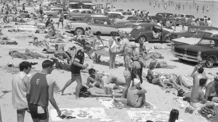 People are pictured at the beach in a story about 1960s slang terms