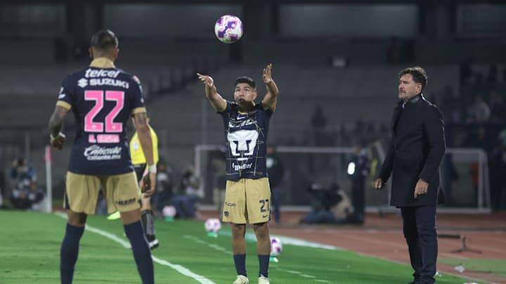 Piero Quispe #27 of Pumas UNAM makes a throw-in with the...