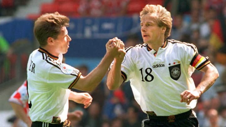 German player Stefan Reuter (L) congratulates capt