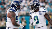 Oct 12, 2025; Jacksonville, Florida, USA;Seattle Seahawks defensive end Leonard Williams (99) and linebacker DeMarcus Lawrence (0) celebrate after a play against the Jacksonville Jaguars at EverBank Stadium. 