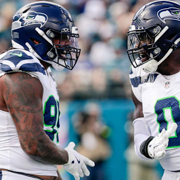 Oct 12, 2025; Jacksonville, Florida, USA;Seattle Seahawks defensive end Leonard Williams (99) and linebacker DeMarcus Lawrence (0) celebrate after a play against the Jacksonville Jaguars at EverBank Stadium. 