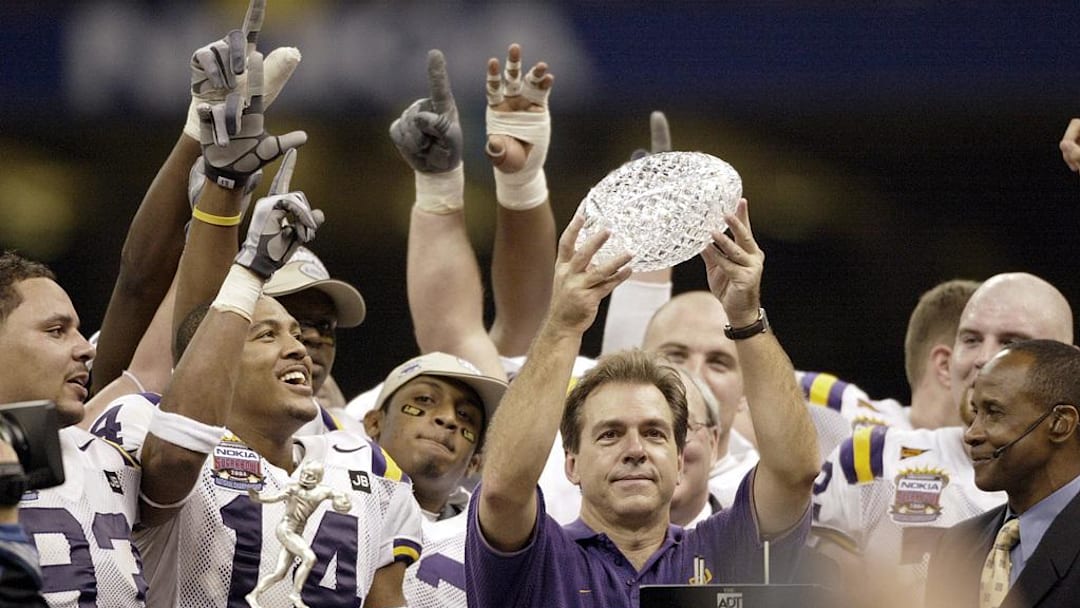 Jan. 4, 2004; New Orleans, LA, USA; Nick Saban, in blue, lifts the BCS National Championship Trophy after the Tigers' 21-14 victory over Oklahoma in the Nokia Sugar Bowl; Mandatory credit: Robert Deutsch-USA TODAY NETWORK
