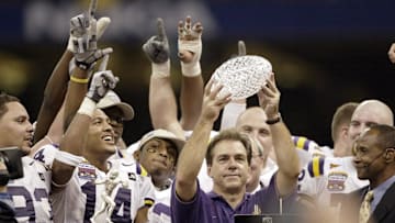 Jan. 4, 2004; New Orleans, LA, USA; Nick Saban, in blue, lifts the BCS National Championship Trophy after the Tigers' 21-14 victory over Oklahoma in the Nokia Sugar Bowl; Mandatory credit: Robert Deutsch-USA TODAY NETWORK