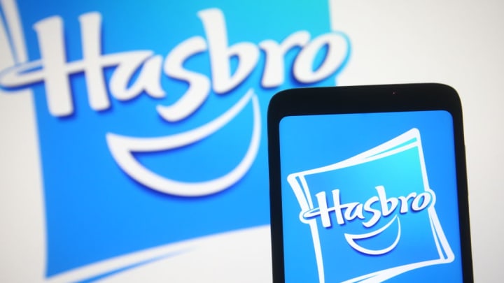In this photo illustration a Hasbro logo is seen on a...