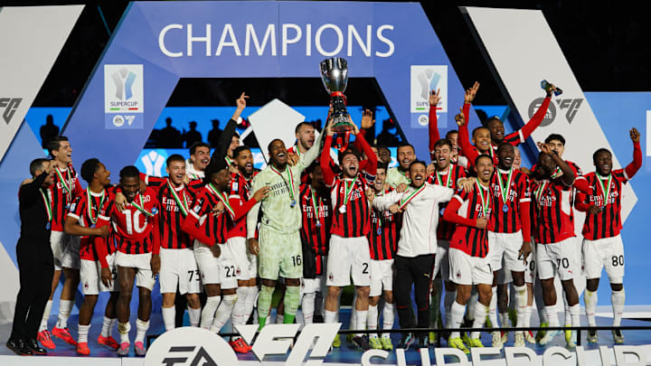 AC Milan's players celebrate with the trophy after winning...