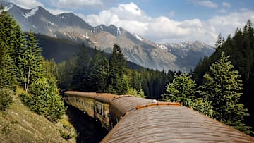 The Rocky Mountaineer crosses Continental Divide in custom coaches through Canadian Rockies.