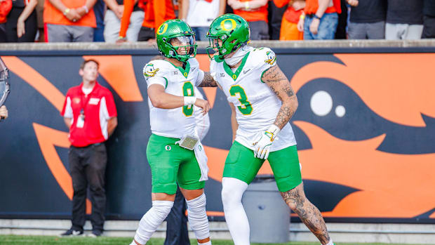 Oregon Ducks quarterback Dillon Gabriel and tight end terrance ferguson celebrate in the win over the Oregon State Beavers