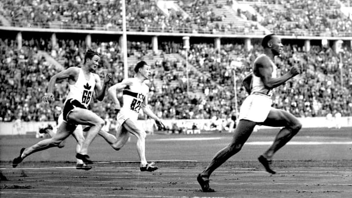 Jesse Owens (right) smokes competitors in the 200-meter sprint at the Berlin Summer Games, setting a new Olympic record.